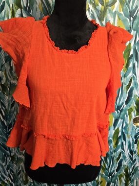 Anthropologie Maeve Cascade Tiered Ruffle Shell Top in a vibrant orange/coral
